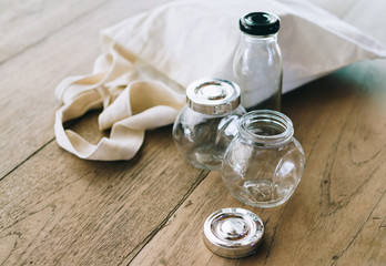 Cloth bag and glass jars on wooden table, no plastic packages, zero waste concept