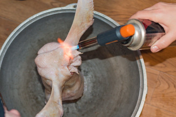 The hostess burns the carcass of a duck