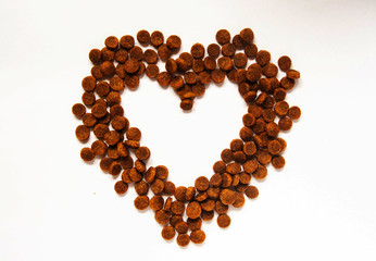 Heart shaped pet food. Food for cats and dogs. Heart with place for text