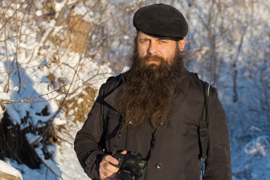 A man with a beard in the snow.