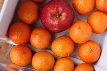 Ripe apples and oranges on the table