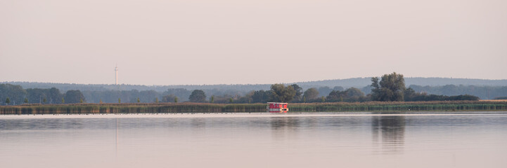 Houseboat on a lake during sunrise