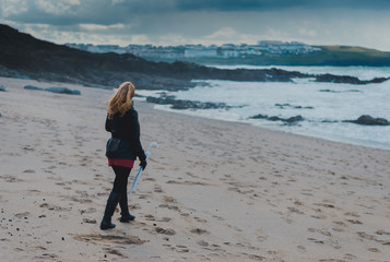 Woman walking on the beach just before the storm