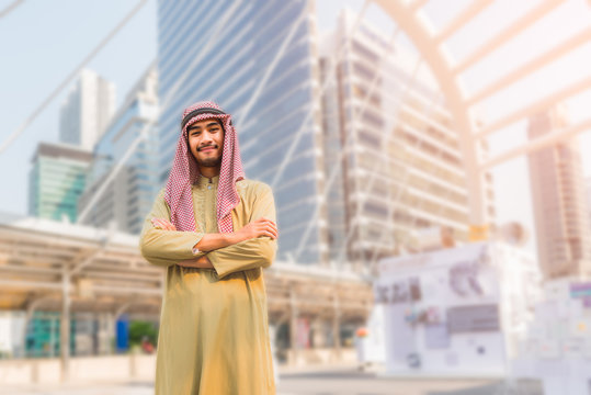 Portrait of handsome arabian man standing arms crossed and happy smilling