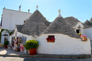The traditional Trulli houses in the street of Alberobello city, Italy, Apulia region, Adriatic Sea with typical souvenir shop