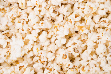 close up tasty scattered salted popcorn texture background