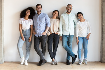Fototapeta premium Portrait of smiling multiethnic friends posing together