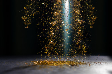 Abstract dark background with flying sequins.