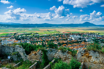 Landscape photo taken from the Rasnov Citadel showing the Rasnov city and the mountains in the distance - Rasnov, Brasov country, Transylvania, Romania