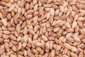 Beautiful selected organic pistachios in shell background, lots of pistachios in shell on a market counter.