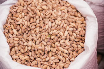 Beautiful selected organic pistachios in shell background, lots of pistachios in shell on a market counter.