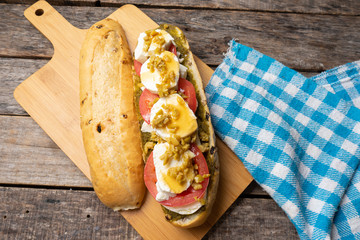 Goat cheese and honey sub sandwich on wooden background