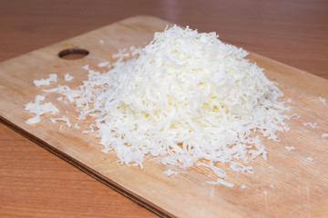 Organic Shredded Sharp Cheese on a Cutting Board