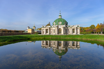 The picturesque pavilion is located on the Bank of a pond in the Park. Autumn day is Sunny. Kuskovo, Moscow, Russia.