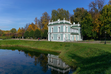 Fototapeta na wymiar The picturesque pavilion is located on the Bank of a pond in the Park. Autumn day is Sunny. Kuskovo, Moscow, Russia.