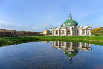 Fototapeta na wymiar The picturesque pavilion is located on the Bank of a pond in the Park. Autumn day is Sunny. Kuskovo, Moscow, Russia.