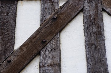 Vintage brick wall typical English masonry background with wooden logs black and white