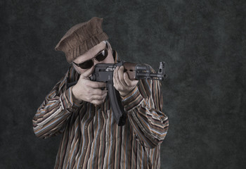 a man with a Kalashnikov assault rifle