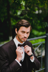 Close-up portrait of handsome young bridegroom with elegant stylish haircut