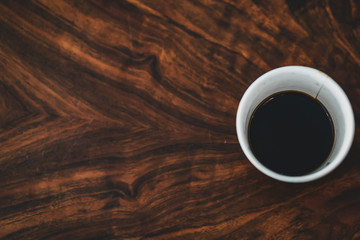Cup coffee on texture wooden working space. copy space