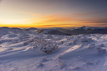Naklejka na ściany i meble Mountain winter landscape in the Ukrainian Carpathians on the background of the sunset.