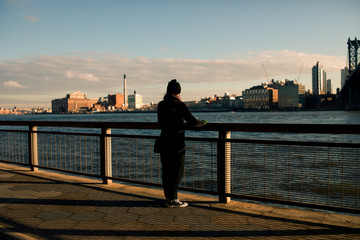 Fototapeta premium Young Woman Looking over the Hudson River in New York City