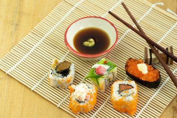 Sushi set on wooden table.
