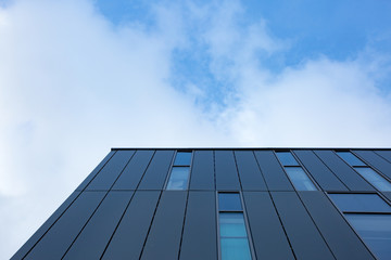 Fototapeta na wymiar blue sky and clouds reflected in windows of modern building