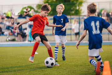 Young boys playing soccer game. Training and football match between youth soccer teams. Junior...