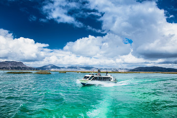Traveling by boat at Titicaca lake near Puno, Peru