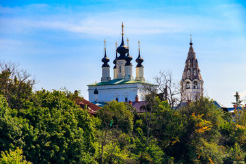 Fototapeta na wymiar View of the Ascension Church with a bell tower of St. Alexander monastery, located on the left bank of the Kamenka river in Suzdal, Russia. Golden Ring of Russia