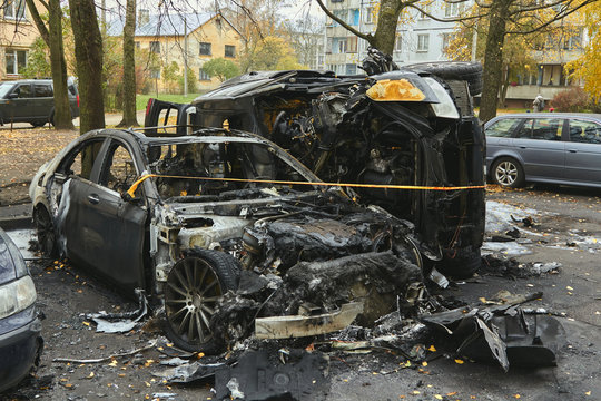 Fully burned cars in the city in autumn