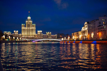 View of illuminated Stalin skyscraper on the festive illumination Kotelnicheskaya embankment and...