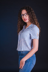 Young girl model posing with white and blue shirt in black background