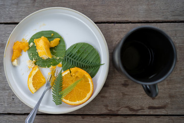 cup coffee, orange cake on wooden table.