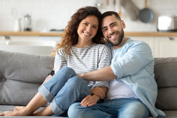 Fototapeta Portrait of couple posing photo shooting seated on couch indoors obraz