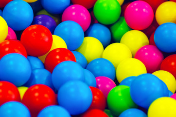 Fototapeta na wymiar Small multi colored plastic baby balls, background texture