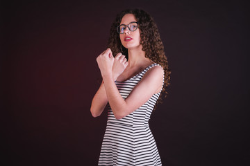 Naklejka premium Young girl model posing with cute dress in black background