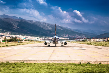 Modern passenger plane at airport lane moving to take off , Cusco , Peru.