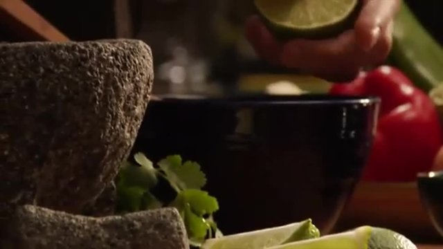mexican chef reams lime for a guacamole