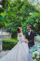 Laughing couple of newlyweds near the stylish decorated table