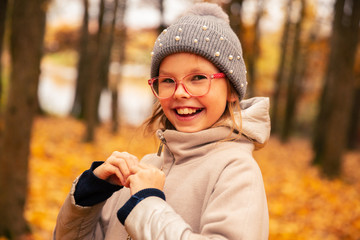 autumn portrait of a little girl.positive girl