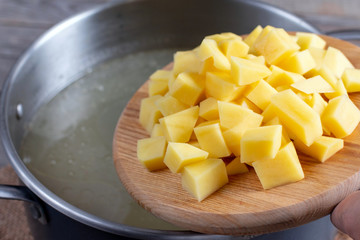 Cooking soup. Chopped potatoes in soup