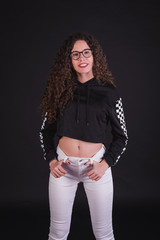Young girl model posing with cute racing sweater in black background
