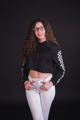 Young girl model posing with cute racing sweater in black background