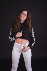 Young girl model posing with cute racing sweater in black background