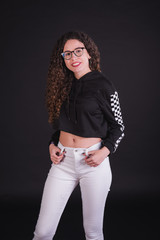 Young girl model posing with cute racing sweater in black background