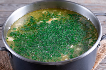 Cooking soup. Greens in a pot with soup