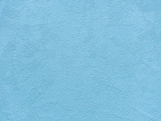 Luxurious blue background with a rough surface. Textured surface in a pleasant blue color