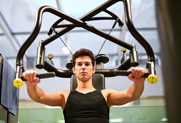 Man using a chest press machine in a gym